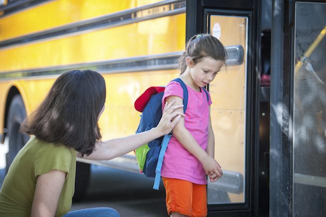 Don't be fooled. She's actually pushing that child onto the bus.